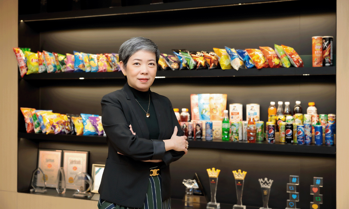 Female manager standing in front of Pepsi Products and awards