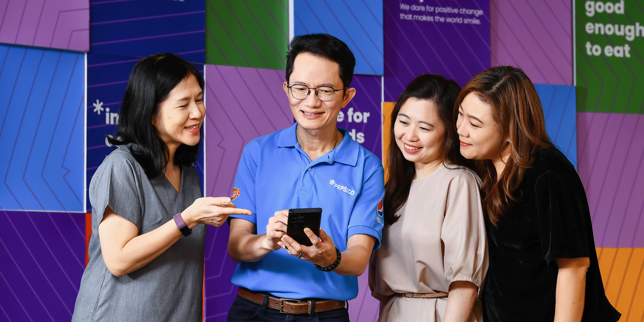 Employees gathered around a phone